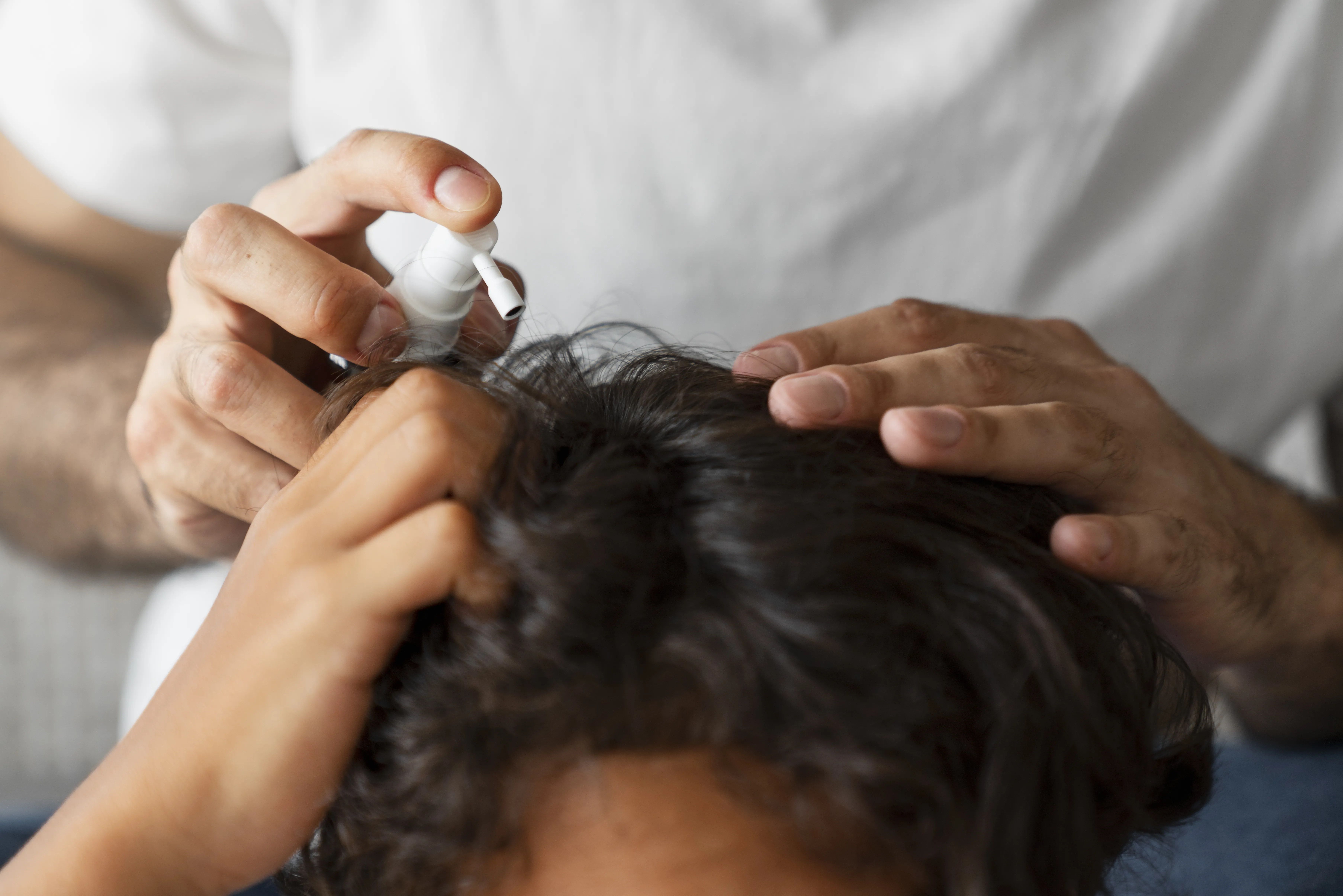 high-angle-hand-holding-lice-treatment
